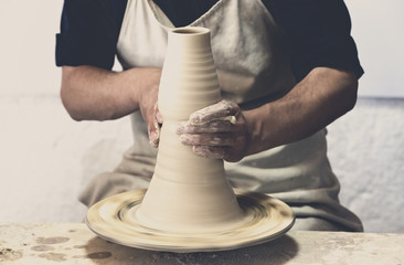 Potter makes pottery handmade in the workshop 