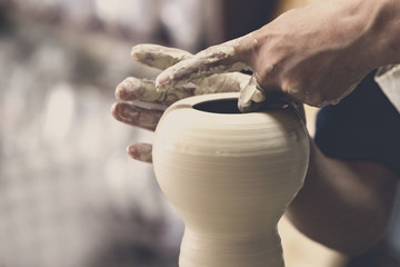 Potter makes pottery handmade in the workshop 