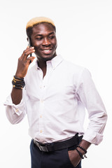 Isolated portrait of a young and handsome African American man wearing glasses and a suit talking on a phone and smiling