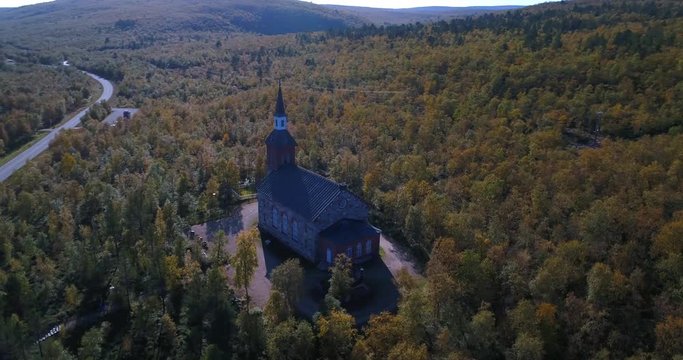 Arctic church, Cinema 4k aerial view around utsjoki church, near mantojarvi lake and utsjoki town, on a sunny autumn day, in Lapland, Lappi, Finland