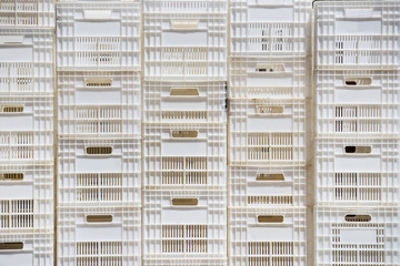 Background of white plastic boxes stacked in stock 