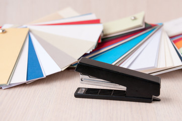 Set of designer paper and a black stapler on the table