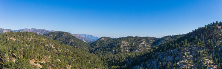 Evening light casts shadows on the tops of mountains in the southern California Angeles National Forest.