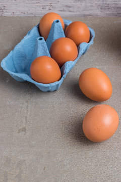 Eggs. Chicken eggs in the package on a cement background. Chicken eggs in a cardboard box.