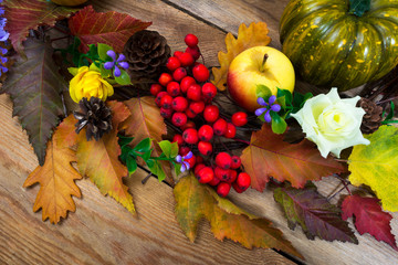 Thanksgiving background with fall leaves, lilac flowers and rowan berries, top view