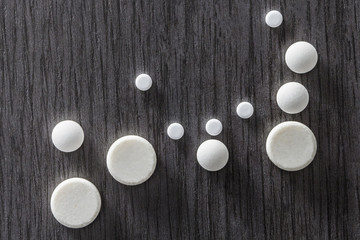  Some Round White Pills Of Different Size 
