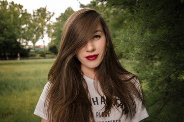 Naklejka premium Pretty messy long hair girl in park 