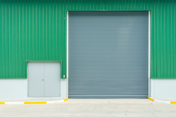 Shutter door or roller door and concrete floor outside factory building use for industrial background.