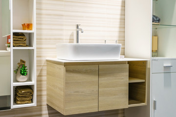 Naklejka na ściany i meble modern bathroom interior in foreground of counter top washbasin in a contemporary style using natural materials.