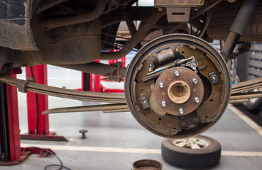 changing wheels on a car garage with soft-focus and over light  in the background