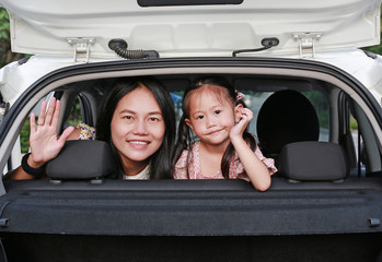 Happy holidays. Mother and her daughter in the car.