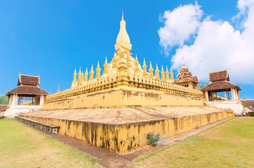Laos travel landmark, golden pagoda wat Phra That Luang in Vientiane. Buddhist temple. Famous tourist destination in Asia.