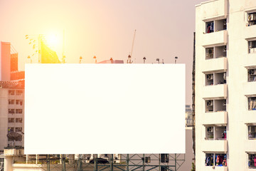 Obraz premium Road with lanterns and large blank billboard at evening in city : Bangkok : Thailand