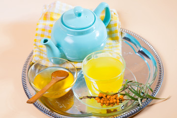 Tea made from sea buckthorn berries healthy for health delicious, saturated with vitamins surrounded by berries and sea buckthorn leaves for family tea drinking and maintaining health in the body