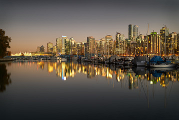 Fototapeta na wymiar Coal Harbor Twilight, Vancouver. A calm Coal Harbor next to Stanley Park at twilight. Vancouver, British Columbia.
