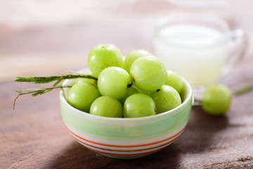 Indian gooseberry fruit and juice on wooden background,healthy food