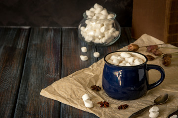Hot chocolate or cacao in a blue mug with marshmallows