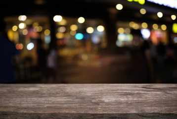 Empty dark wooden table in front of abstract blurred bokeh background of restaurant . can be used for display or montage your products.Mock up for space.
