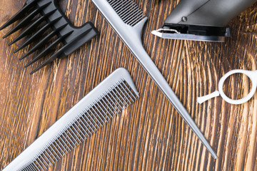 set of tools for men's hair cutting, on a wooden background