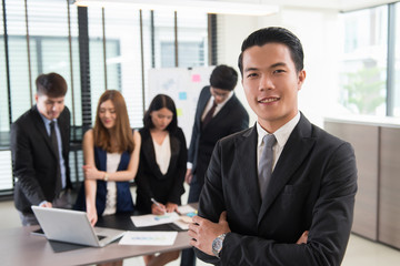 Portrait of smiling businessman in office,teamwork concept.