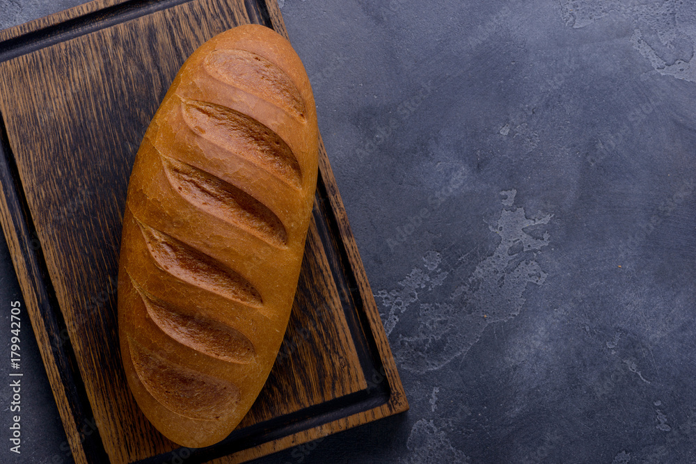 Wall mural fresh bread on cutting board