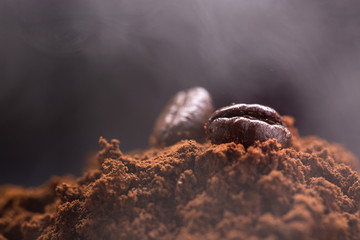 pile of ground coffee, and at the top several whole coffee beans.