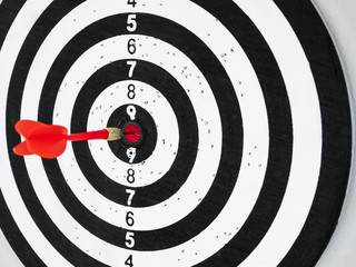 Dart board with red arrow hit center Target Goal concept