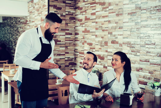 Waiter taking order in restaurant