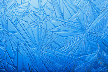 Frozen crystals on the glass. Abstract background. New year pattern.