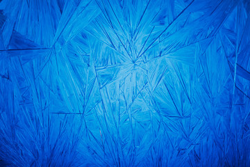 Frozen crystals on the glass. Abstract background. New year pattern.