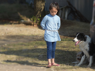 little girl wearing denim outfits feeling unhappy and being with a dog in a farm, filtered tones