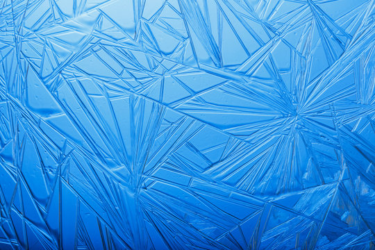 Frozen crystals on the glass. Abstract background. New year pattern.