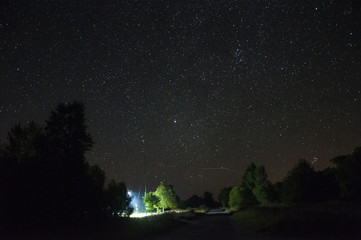 Starry sky above the road in the village