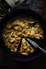 Christmas apple pie with a cut piece and knife on a baking sheet. Rustic style. Flat lay