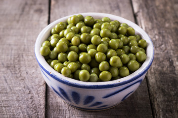 canned Green peas l on old wooden background,healthy vegan food