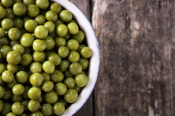 canned Green peas l on old wooden background,healthy vegan food