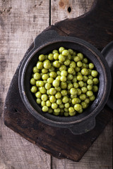 canned Green peas l on old wooden background,healthy vegan food