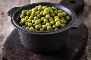 canned Green peas l on old wooden background,healthy vegan food