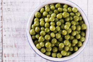 canned Green peas l on old wooden background,healthy vegan food
