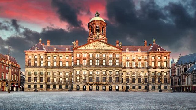 Royal Palace on the dam square in Amsterdam, Netherlands, Time lapse at sunset.