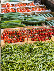 Wooden crates with different vegetables in the market place.