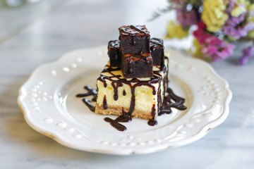 Homemade chocolate cheesecake topping brownie and dark chocolate sauce