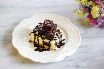 Homemade chocolate cheesecake topping brownie and dark chocolate sauce