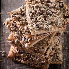 Crunchy crispbread on a wooden background. Healthy snack: cereal crunchy multigrain cereal flax seed ,sesame, sunflower seeds protein bread bar.