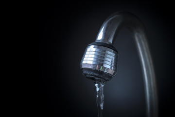 closeup water flowing from opened faucet