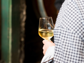 Woman holding glass of white wine