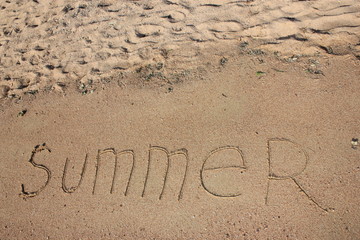 Summer text is written on sand