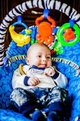 The little boy is in the baby chair