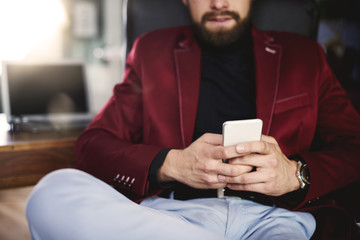 Unrecognizable businessman using his a mobilephone
