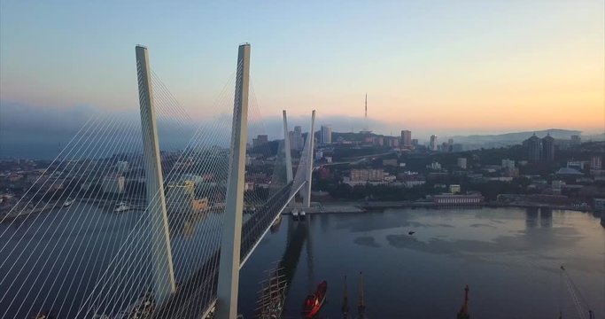 Great aerial view of the Zolotoy Bridge (the Golden Bridge) that is cable-stayed bridge across the Zolotoy Rog built in 2012 in Vladivostok, Russia. Autumn sunrise